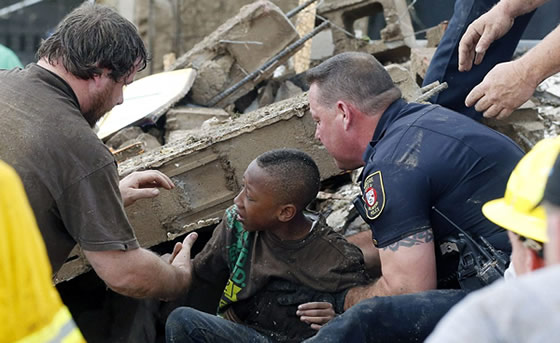 A boy is pulled from beneath a collapsed wall at the Plaza Towers Elementary SchoolCredit: AP